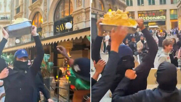 Saqueadores se llevan un recipiente de helado durante disturbios en Milán